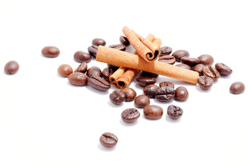 coffee beans and cinnamon sticks on white