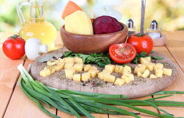 Composition of vegetables on plate on nature background