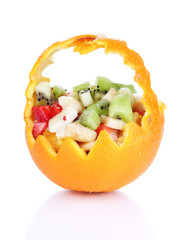 Fruit salad in hollowed-out orange isolated on white