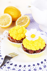 Beautiful lemon cupcakes on dining table close-up