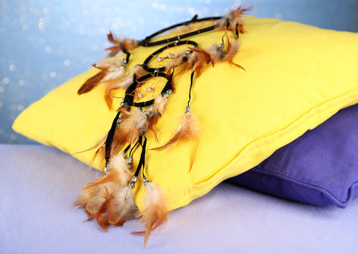 Beautiful dream catcher and pillows on blue background