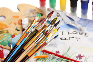 Many brush in paint on bright background