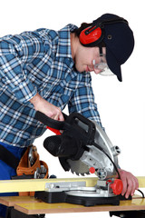 Fototapeta premium Man using a miter saw