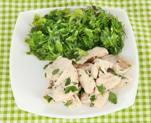 Boiled meat on plate on napkin close-up