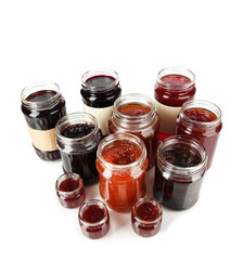 Tasty jam in banks isolated on white