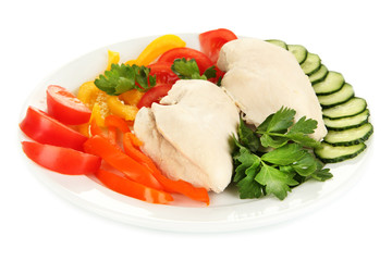 Boiled chicken breast on plate with vegetables close up