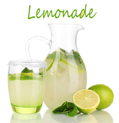 Lemonade in pitcher and glass isolated on white