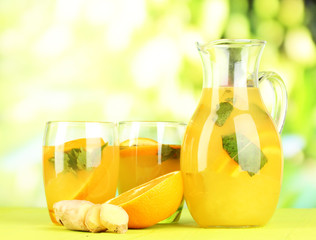 Orange lemonade in pitcher and glasses