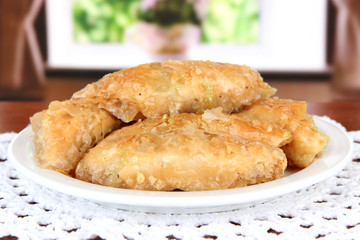 Sweet baklava on plate on table in room
