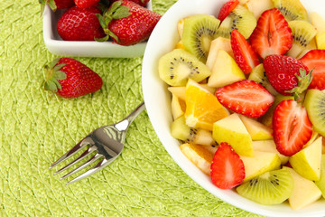 Useful fruit salad of fresh fruits and berries in bowl