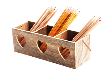 Different pencils in wooden crate, isolated on white