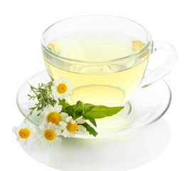 Cup of herbal tea with wild camomiles and mint, isolated