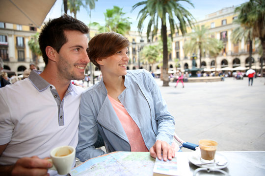 Couple In Barcelona Sitting At Restaurant Table In Plaza Real