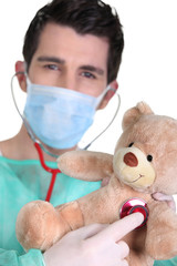 doctor listening to teddy bear heartbeat