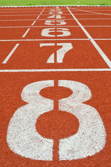 numbers on running tracks of outdoor athletic stadium