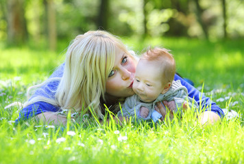 Young mother with her little boy in the park together.