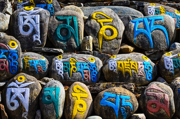 Tibetan religious budhist symbols on stones - obrazy, fototapety, plakaty