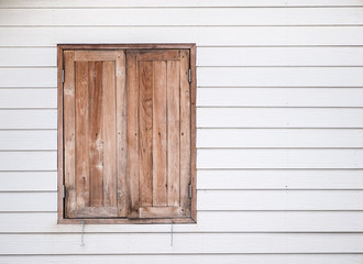Obraz na płótnie Canvas Closed vintage wooden window on white wall