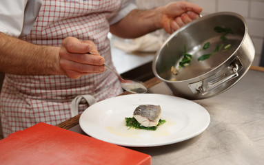 Obraz na płótnie Canvas Chef is serving boiled seabass