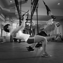 Fitness TRX training exercises at gym woman and man