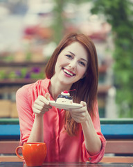 Style redhead girl with cake and cup