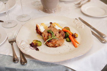 Decent piece of meat on beige porcelain plate