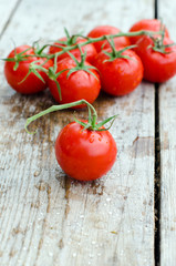 .Fresh cherry tomatoes on a wooden table