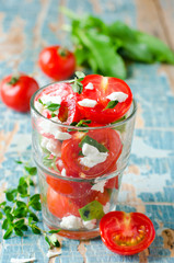 Salad of fresh cherry tomatoes with herbs and cheese