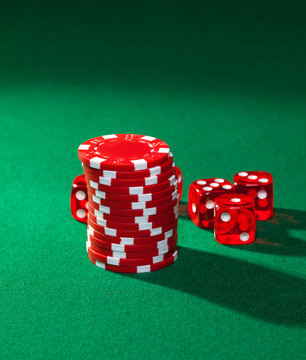 Red poker chips and red dice