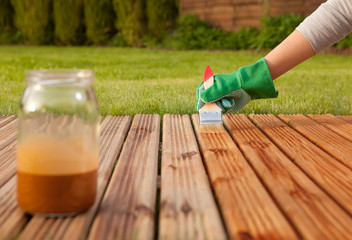 Painting wooden patio deck with protective varnish