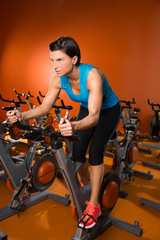 Fototapeta na wymiar Aerobics spinning woman exercise workout at gym