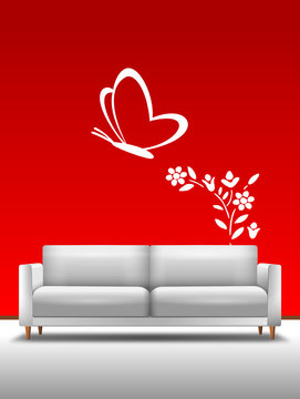 Sofa vor roter Wand mit Bild