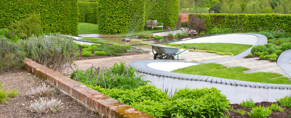 sprinkler watering the lawn and garden on a hot summers day