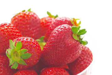 Close up view of strawberries on white