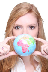 young woman showing a little globe