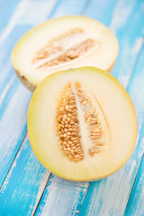 Ripe Galia melon cut in two halves, vertical shot