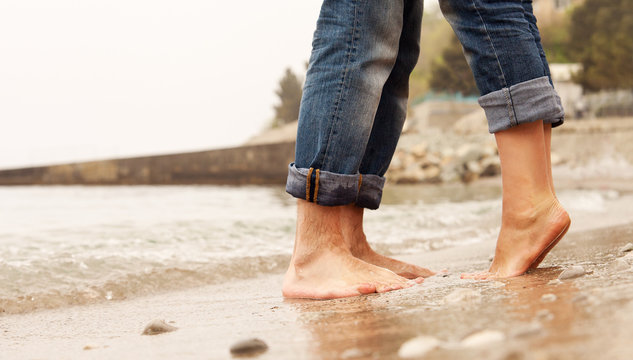 Closeup image couple legs at the beach