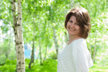 A woman in a birch grove