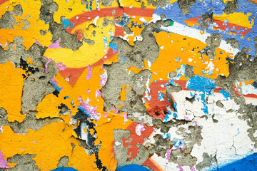Colourful remnants of peeling graffiti