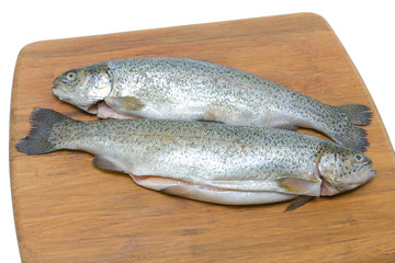 trout on a cutting board on a white background