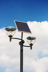 Solar powered street lights, cloudy sky background