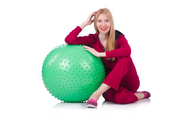 Young woman with ball exercising on white