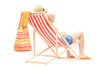 Young man enjoying on a beach chair