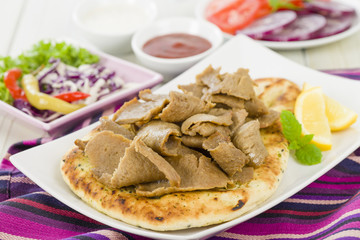 Donner Meat on Naan - Slices of donner meat on a flatbread