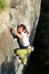 A man climbs a wall.