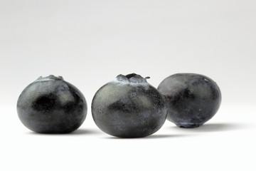 Close up of blueberries on the white background