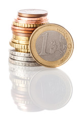 A standing 1 Euro coin - currency of European Union - leaning on