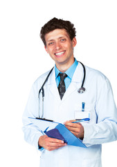 Young smiling doctor writing on a patient's medical chart on whi
