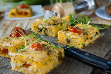 polenta with cheese cut into small squares on the board