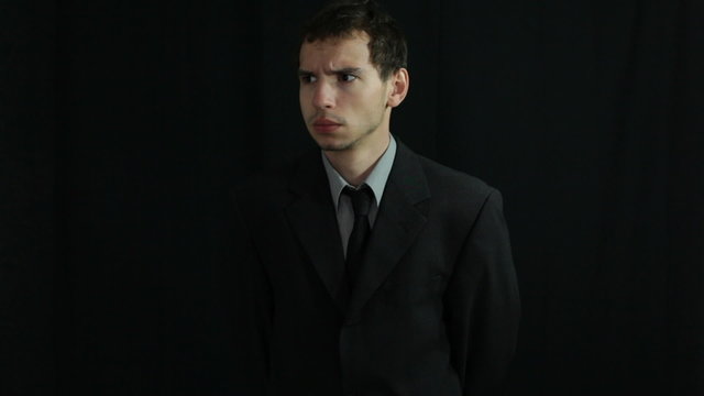 Serious businessman over dark background